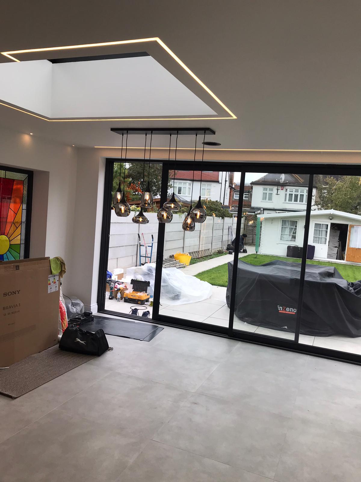 Open-plan rear house extension with glass roof lantern, built by builders in West London