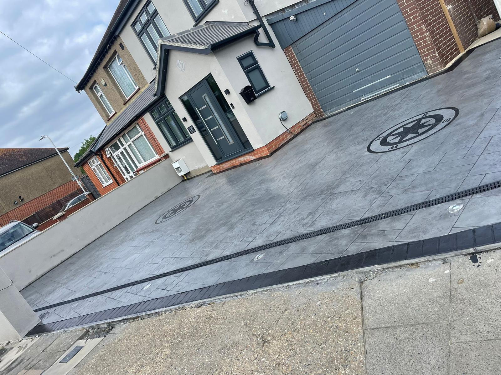 Imprinted concrete driveway with compass medallion design, installed by builders in West London